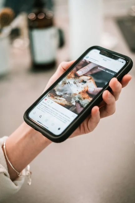 Close-up of hands interacting with a smartphone for online scheduling, showcasing modern digital convenience.